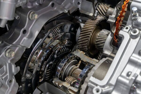Widoczna jest szczegółowa struktura mechaniczna podczas naprawy skrzyni biegów.